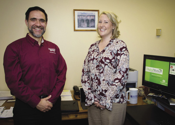 Dr. Roberto Gallardo and Lara Bowman standing in an office, in front of computer monitor.