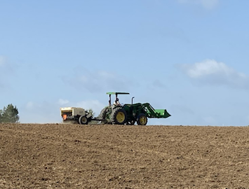 Tractor on dirt field.