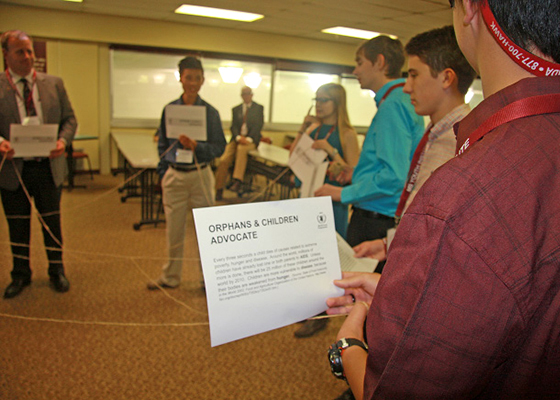 group of participants in a circle connected by string.