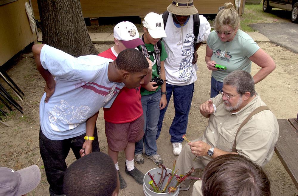 Bug Camp attendees get a lesson from John Guyton, Extension Service entomology specialist, about why and how carnivorous pitcher plants consume insects. (Submitted photo)