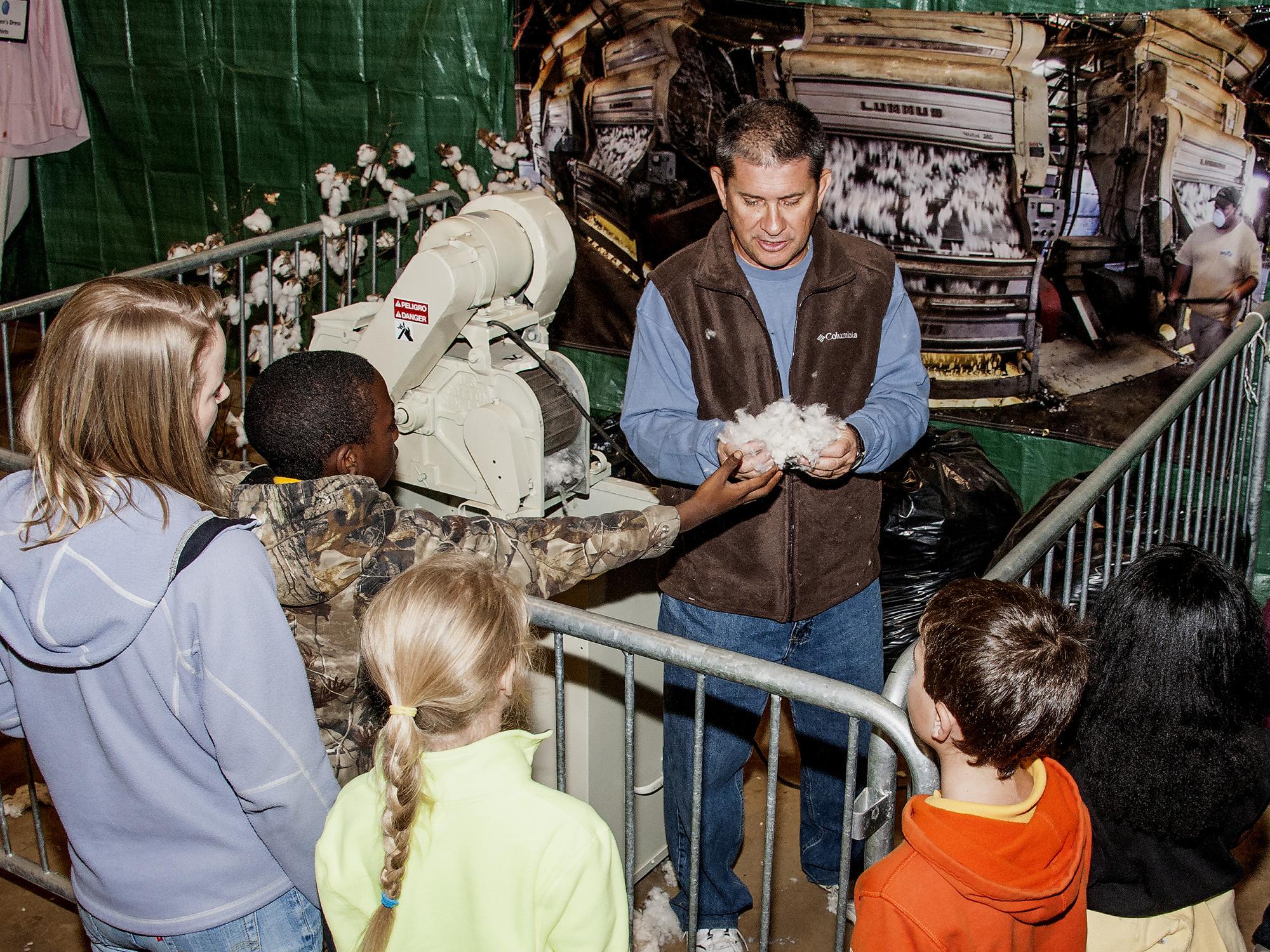 Mississippi State University Extension Service regional agronomic crops specialist Dennis Reginelli shows students cotton at the FARMtastic Mighty Crops station on Nov. 11, 2013. The third annual FARMtastic will take place this year from 9 a.m. until 1 p.m. Nov. 10-15 at the Mississippi Horse Park near Starkville. (File photo by MSU Ag Communications/Scott Corey)