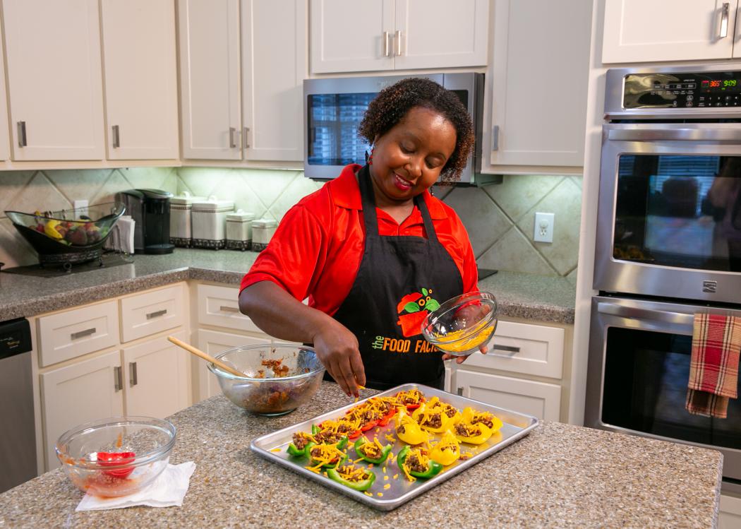 A woman prepares Bell Pepper Nachos in a kitchen.