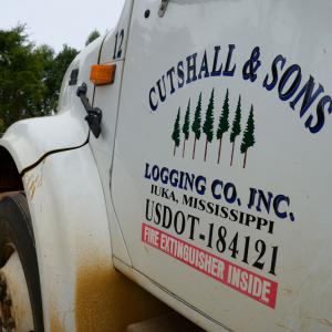 Close up of a truck door listing “Cutshall & Sons Logging Co.”