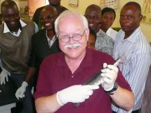 Dr. Skip Jack, Mississippi State University veterinarian, spent three weeks in Nigeria teaching about fish health. Here, he holds a Clarius catfish with some students in Lagos, Nigeria. (Submitted Photo)