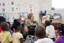 Melissa Tenhet, project director for the Mississippi Child Care Resource and Referral Network shares a story with the preschool students at the Brickfire Project after completing literacy pre-assessments through Starkville Rotary's community service project. (Photo by MSU Extension Service/Alicia Barnes)