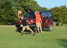 Reece McReynolds, a fifth-grader at Henderson Ward Stewart Elementary in Starkville, winds up to hurl a disc while his father, Eddie, coaches from the side. The McReynoldses practiced together near the Starkville Sportsplex on Sept. 3, 2014. (Photo by MSU Ag Communications/Linda Breazeale)