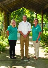 Brett Rushing, an assistant Extension and research professor at the Mississippi State University Coastal Plain Branch Experiment Station, works with Neeley Norman, left, and Sarah Kountouris on the Wildflower Trails of Mississippi, a program coordinated by Keep Mississippi Beautiful intended to turn Mississippi roadsides into pollinator habitats and tourist attractions. Norman is assistant director of Keep Mississippi Beautiful, and Kountouris is director. (Photo by MSU Extension Service/Kat Lawrence)