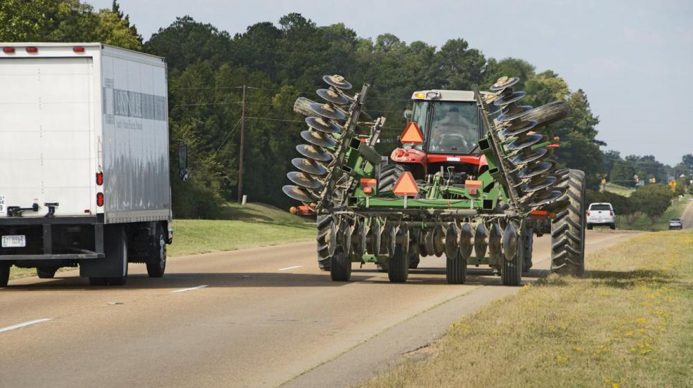 Combine driving on the road.