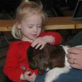 Two-year-old Jewell Vandevere, of Yazoo City, pats a four-day-old Boer goat during the Dixie National Junior Livestock Show.