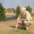 Dr. Wayne Wells adjusts a pop-up irrigation head for best coverage at the R. Rodney Foil Plant Science Research Center at Mississippi State University's North Farm. (Photo by Marco Nicovich)