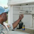 Carl Blair checks thermometers that record the 24-hour high and low temperatures.