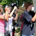 4-H Technology Conference participants, from left, Tara Roberts and Shelly Guy, both of George County, and Devin Doole of Marshall County focus their cameras on a praying mantis during a photo safari. They were taking part in the digital photography track during the three-day camp held at Mississippi State University. (Photo by Jim Lytle/Mississippi State University Ag Communications)