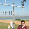 Mark Silva, an Extension associate with the Delta Agriculture Weather Center, checks catfish pond water temperatures. (Photo/ Robert H. Wells)