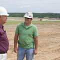 MAFES agronomist David Lang, left, talks with North American Coal environmental specialist Judd Sanborn about preparations for planting switchgrass on reclaimed mine land. (Photo by Marco Nicovich)