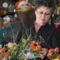 The University Florist staff stays busy preparing arrangements for weddings, parties and other special occasions. Lynette McDougald is preparing these floral arrangements for an event at the Union.