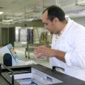 Mississippi State University assistant professor of food safety and microbiology Barakat Mahmoud uses the RS 2400 X-ray machine to rid seafood and produce of harmful bacteria. Here, he places fresh produce carefully wrapped in plastic into the machine. In a matter of a few minutes, the food is irradiated and ready to eat. (Photo by MSU Ag Communications/Karen Templeton)