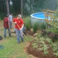 Mississippi State University's Landscape Architecture Delegates volunteered to help the family of a young girl with a serious nerve disorder. David Russell, Dustin Randall and Dale Brasher place plants around the family's pool to keep the soil intact. With the erosion problem solved, the girl can continue her regular pool therapy to ease her chronic pain.