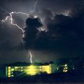 A brilliant streak of lightning flashes over Suttle Hall, north of Mississippi State University, during a summer storm in this archived photo. (Photo by MSU Geosciences/Michael Brown)