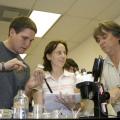 Each fall, scientists from all over the world flock to Mississippi State University to learn the latest in insect-rearing techniques. Blaine Junfin of Kunafin Insectaries and international participants Tara Van Beelen and Neil Naish identify insect pathogens in an MSU lab. (Photo by Kat Lawrence)