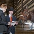 Union County 4-H youth agent Gina Wills and 4-H member Bobby May of Marshall County review the show schedule for the Winter Classic Horse Show held at the Mississippi Horse Park near Starkville. May and his horse, Jack, took part in the series of off-season shows from January through March. (Photo by Scott Corey)