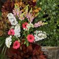 Floral designs, such as this display by Lynnette McDougald of The University Florist, can combine potted plants, collected materials and cut flowers to create wedding d&eacute;cor that is reusable and environmentally friendly. (Photo by Scott Corey)