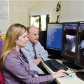 Drs. Andrew Mackin, Erin Brinkman and Todd Archer (from left) study pre- and post-procedural images of a tracheal stent patient at Mississippi State University's College of Veterinary Medicine. (Photo by MSU College of Veterinary Medicine/Tom Thompson)