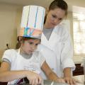 Camper Kendall Willeford of Starkville and Kristin Weaver of Byhalia, a student in the Food Science, Nutrition and Health Promotion program at Mississippi State University, prepare the ingredients for a dish during Fun with Food. (Photo by MSU Ag Communications/Kat Lawrence)