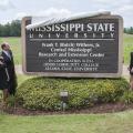 About 200 former colleagues, friends and family members attended the dedication of the Frank T. (Butch) Withers Jr. Central Mississippi Research and Extension Center held July 10 in Raymond. Withers' family members Jaidyn Laird, Caroline Withers, Shelly Withers and Elizabeth Kilgore, along with Mississippi State University President Mark Keenum (at left) and Vice President of the Division of Agriculture Forestry and Veterinary Medicine Greg Bohach, look on as the new sign is revealed. (Photo by MSU Ag Commu