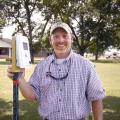 Jason Krutz, irrigation specialist with Mississippi State University's Delta Research and Extension Center, says he believes that soil moisture sensors can save farmers money, conserve water and extend the life of irrigation pumps. Krutz is holding one of the sensors during the Corn and Soybean Field Day in Stoneville, Miss., on July 18, 2013. (Photo by MSU Ag Communications/Linda Breazeale)