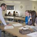 Charles Freeman, assistant professor in the Mississippi State University Apparel, Textiles and Merchandising program, looks at a sketch of a garment with Sarah Ashley Bealor, left, a senior from Tampa, and Rachel Buchanan, a senior from Pontotoc. (Photo by MSU Ag Communications/Kat Lawrence)