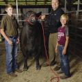 Joe Davis with two 4-H'ers with a champion heifer