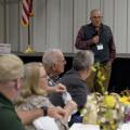 A group of people listen to a public speaker.