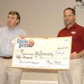 Mike McCain, research and development manager for Mars Food, left, presents a ceremonial $50,000 check to support rice research to Tim Walker, a researcher with the Mississippi Agricultural and Forestry Experiment Station and rice specialist with the MSU Extension Service, in Stoneville, Miss., on July 30, 2013. (Photo by MSU Ag Communications/Linda Breazeale)