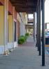 A view down a covered downtown sidewalk.