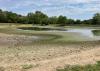 A pond has dried into a fraction of its usual size.